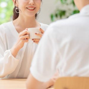 young japanese couple drinking tea in kitchen